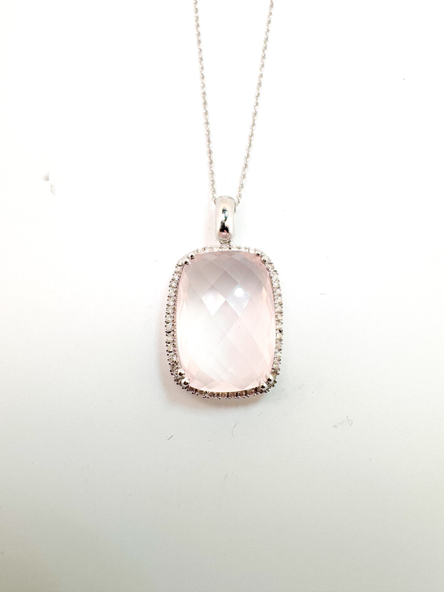 14k, white gold 12.0 carat rose quartz with .20 side diamonds. Pendant