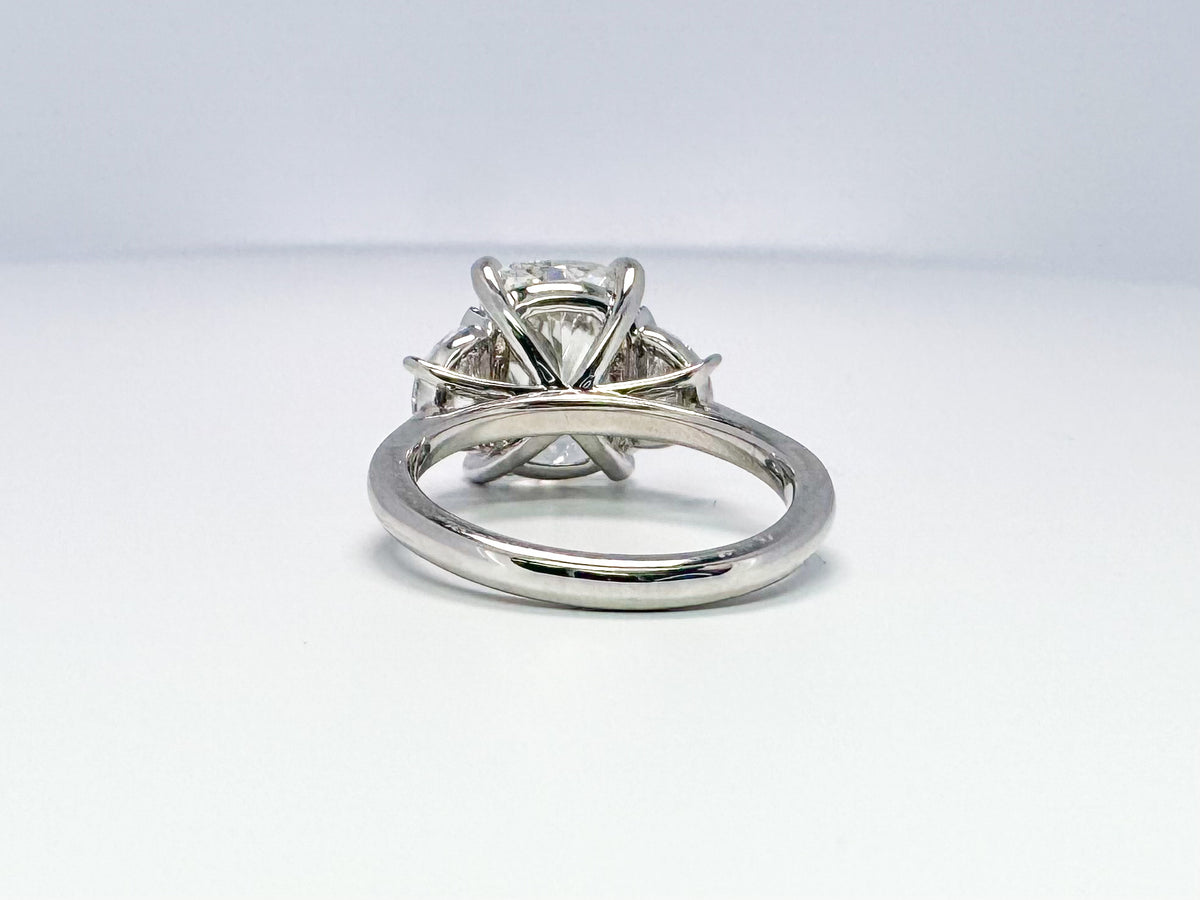 Lab grown 5.09 cushion cut with .90 half moon side diamond engagement ring.