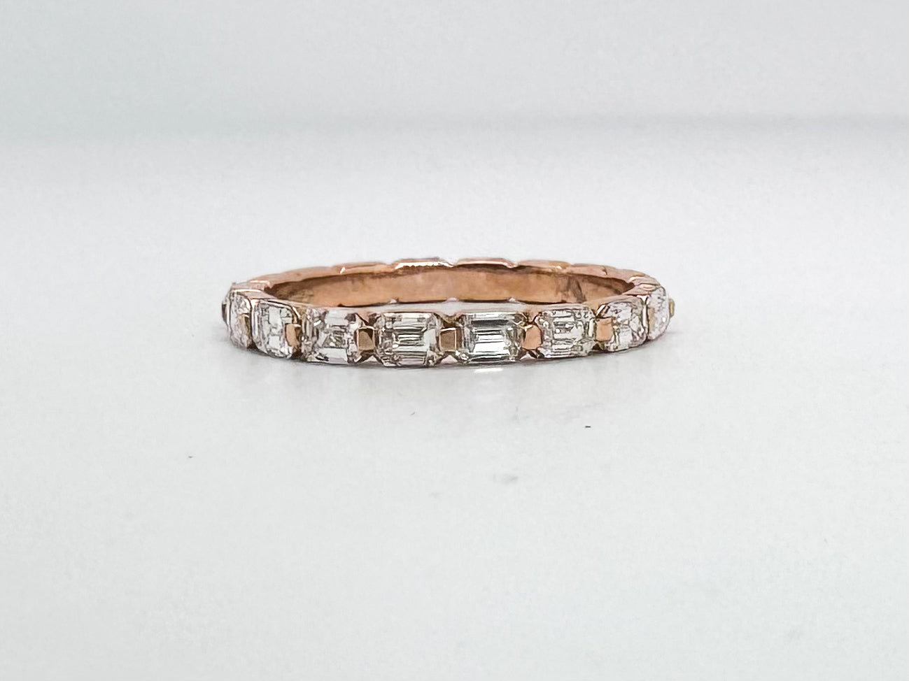 14K, Rose gold, .68 diamond total weight, emerald cut diamond band.