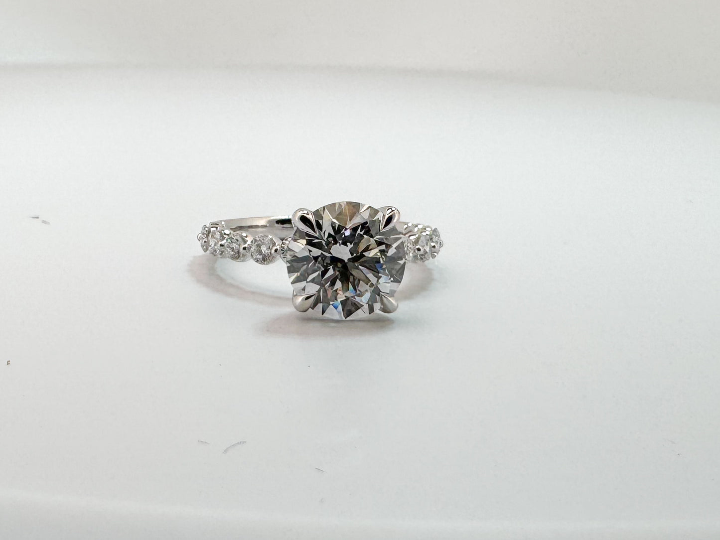 14K, white gold, 3.06 VS2 F Round brillioant set with .52 carats of side diamonds. IGI certified