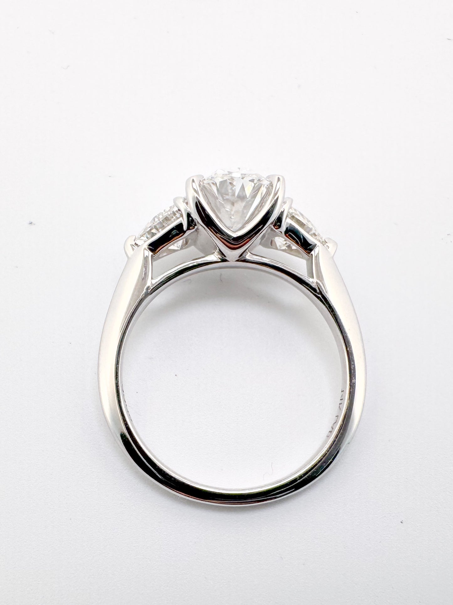 14K white gold 2.02 carat ,oval lab grown center with .98 carats of trillion cut side diamonds.