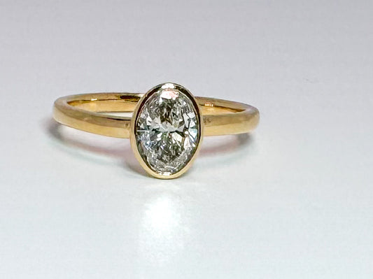 14K, yellow gold .94 bezel set, lab grown, oval diamond engagement ring. VS2 H