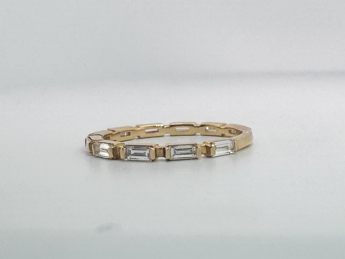 14k, Yellow gold, .60 natural diamond total weight. Baguette diamond band.