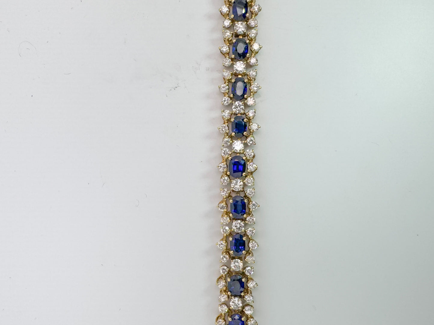 18k, 10.50 carats of natural sapphire surrounded by 9.50 carats of natural diamonds, tennis bracelet.