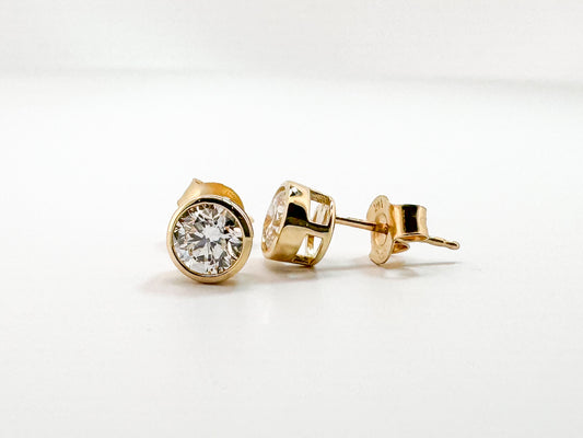 14k, 1.00 ctw lab grown bezel set diamond stud earrings.