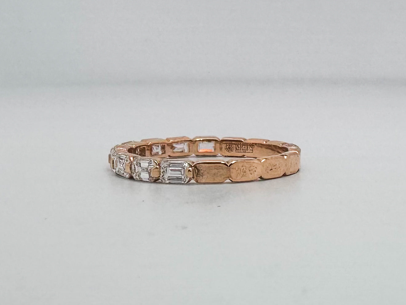 14K, Rose gold, .68 diamond total weight, emerald cut diamond band.