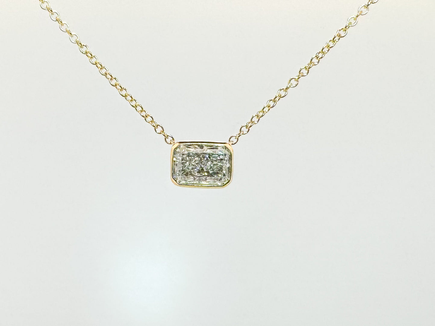 14k, yellow gold .92 sideways lab grown radiant cut, bezel set pendant.