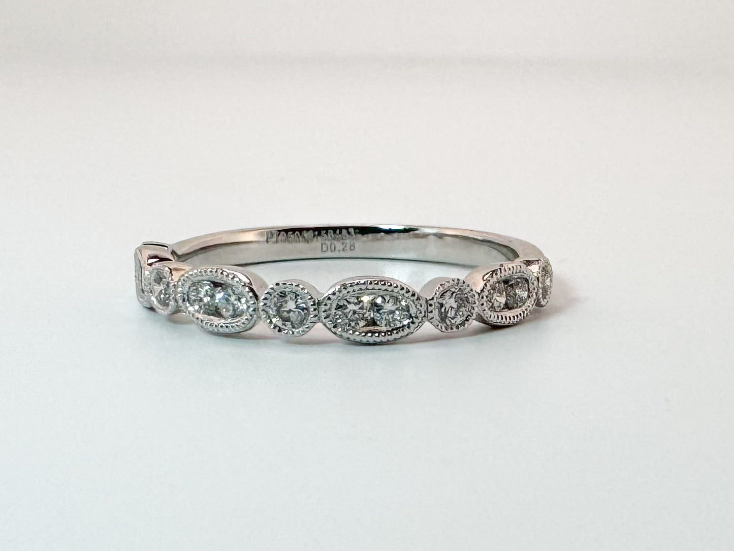 Platinum .28 diamond total weight, milgrain diamond band.