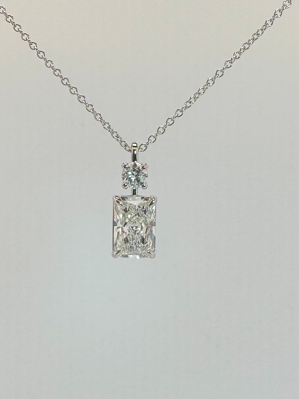 14k white gold , 2.33 carat total weight , Radient and round lab diamond pendant. F VS1