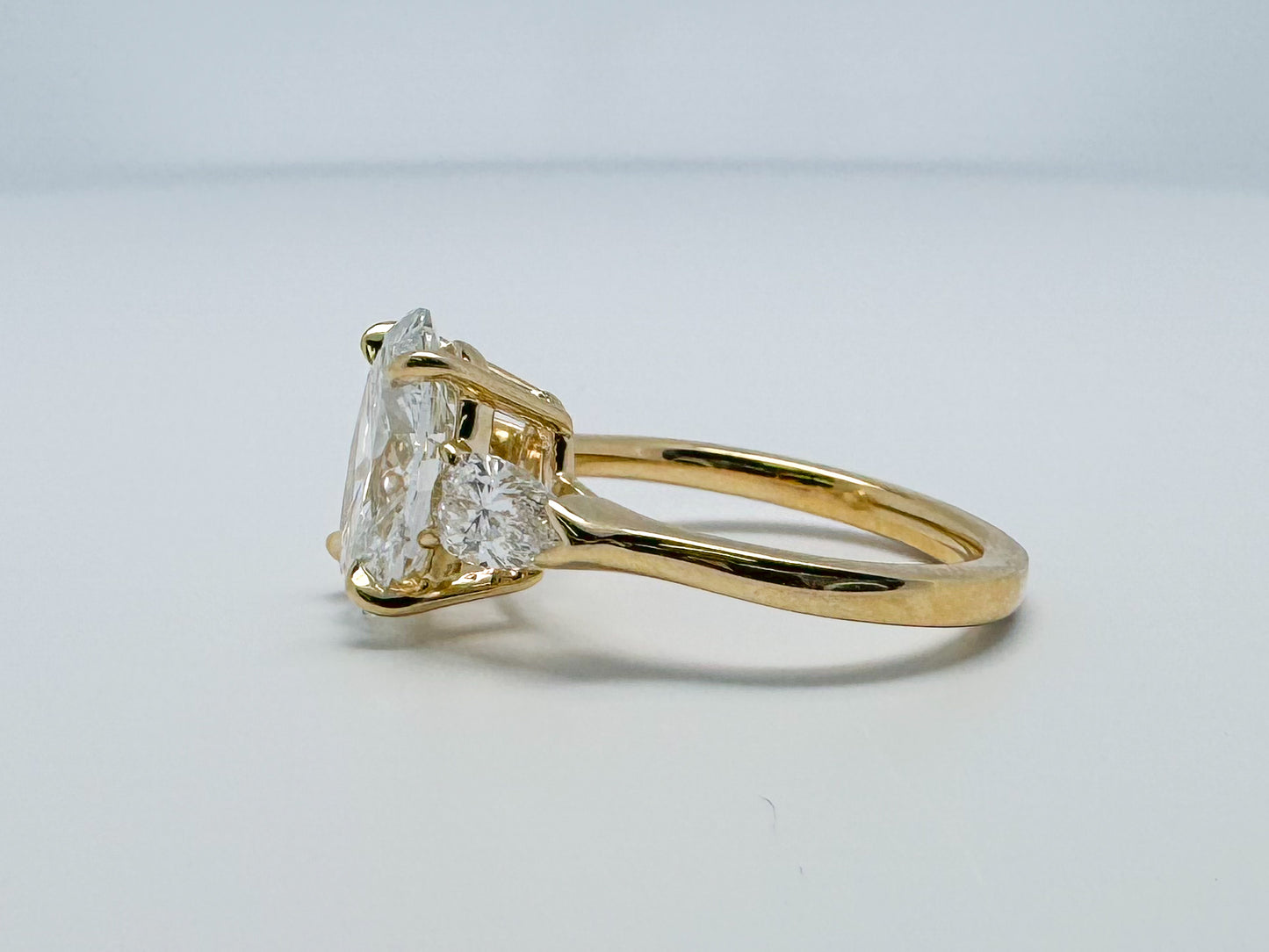 Lab grown three stone diamond ring 3.14 oval set with .62 side diamonds set in 14k yellow gold