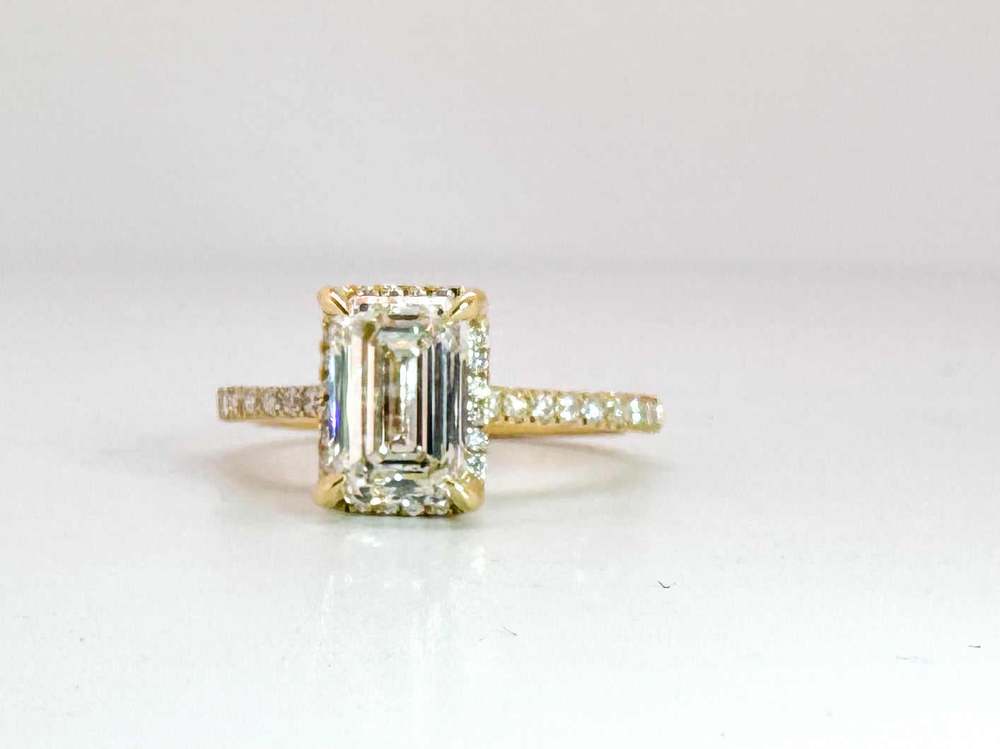 14K, yellow gold 1.78 VS1 G Emerald cut set with .22 side diamonds. Lab grown, IGI Certification