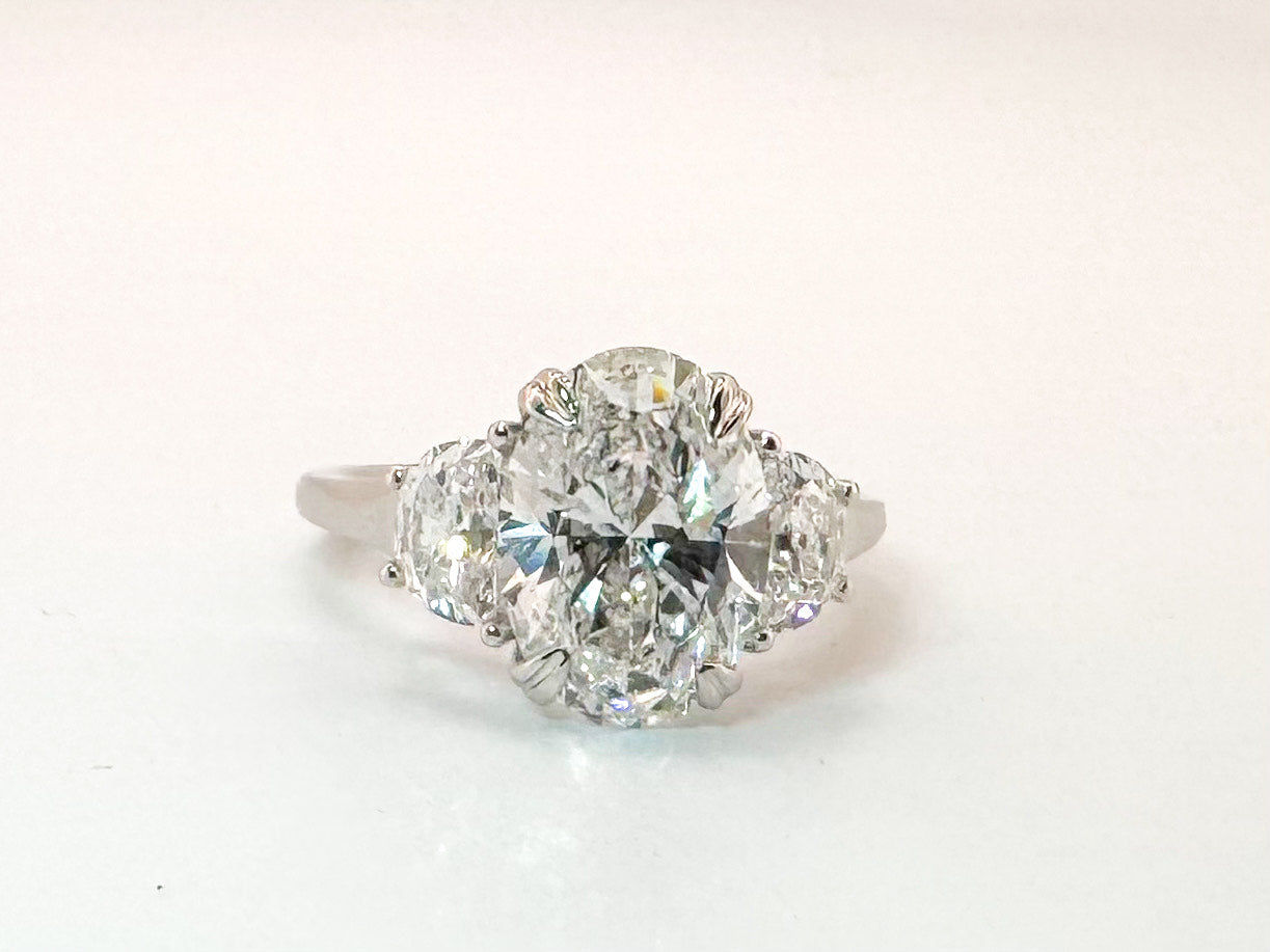 14k white gold 3.02 lab grown oval set with .82 total weight half moon side lab grown diamonds.