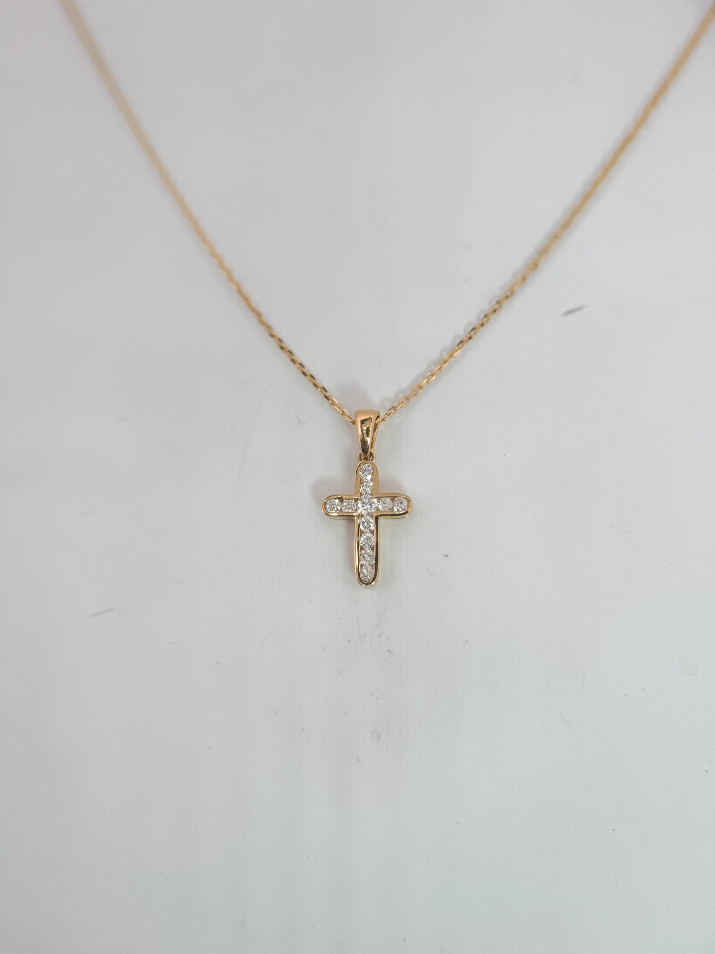 14k, Yellow gold .29 carats of natural channel set diamond cross pendant.