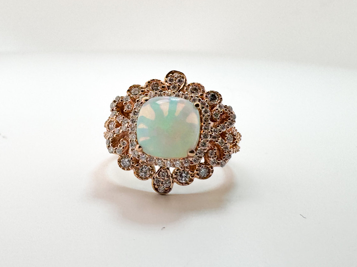 14k, Rose gold, 1.40 carat Ethiopian opal set with .60 carats of side diamonds.