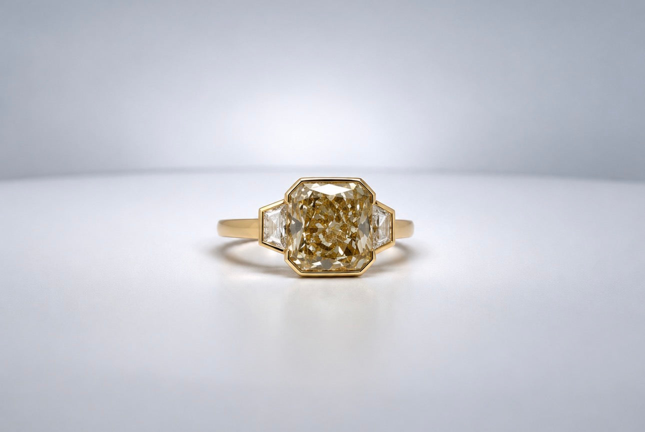 18K, Yellow gold, 4.02 Fancy Yellow, VS2 set with two trapazoid side diamonds equalling .42 carats.