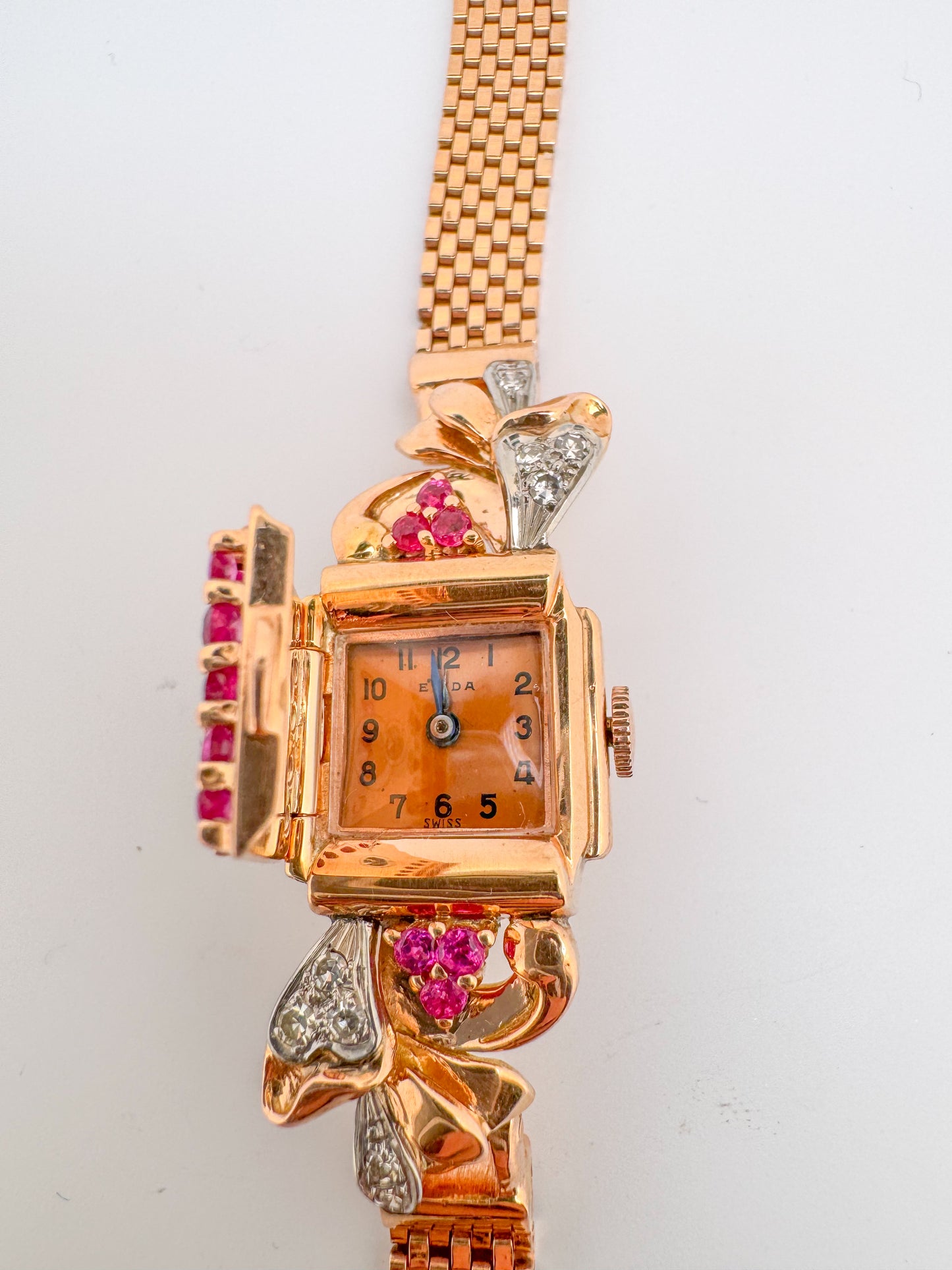 14k, rose gold "Elida" flip watch with .40 side diamond and 1.20 natural ruby.