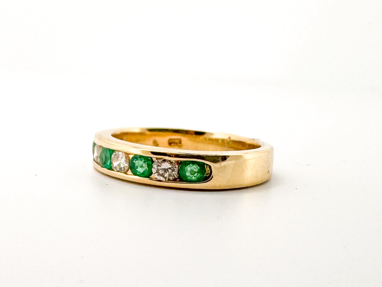 14k, Yellow gold, natural  emerald and diamond channel set band.