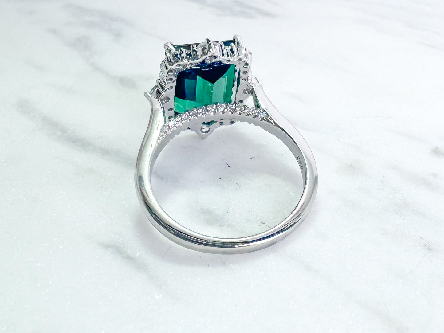 6.33 carat blue green tourmaline with .63 tw side diamond. Set in 14k white gold