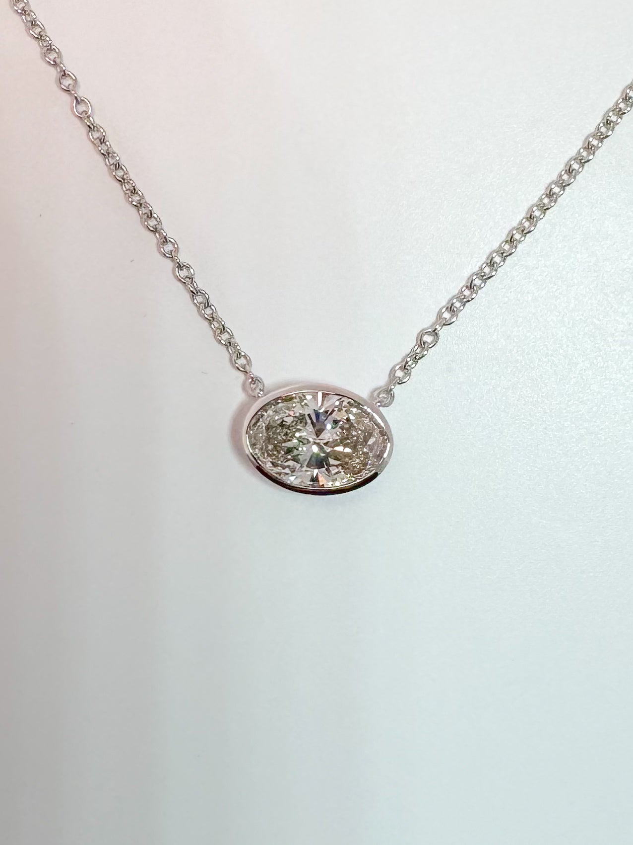 14k, white gold, bezel set, 1.06 lab grown oval diamond pendant.