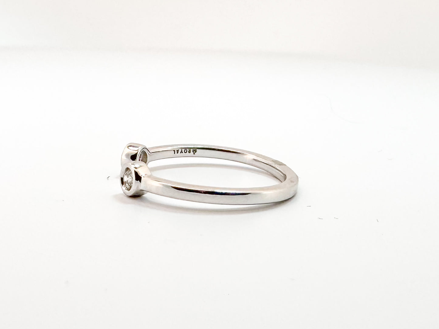 14k, white gold, open concept two diamond ring. .10 carat total weight.