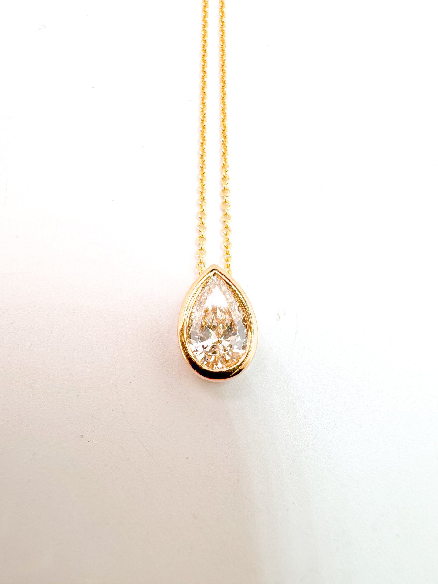 14K, Yellow gold, .50 Pear shaped, lab grown diamond, set in bezel pendant.