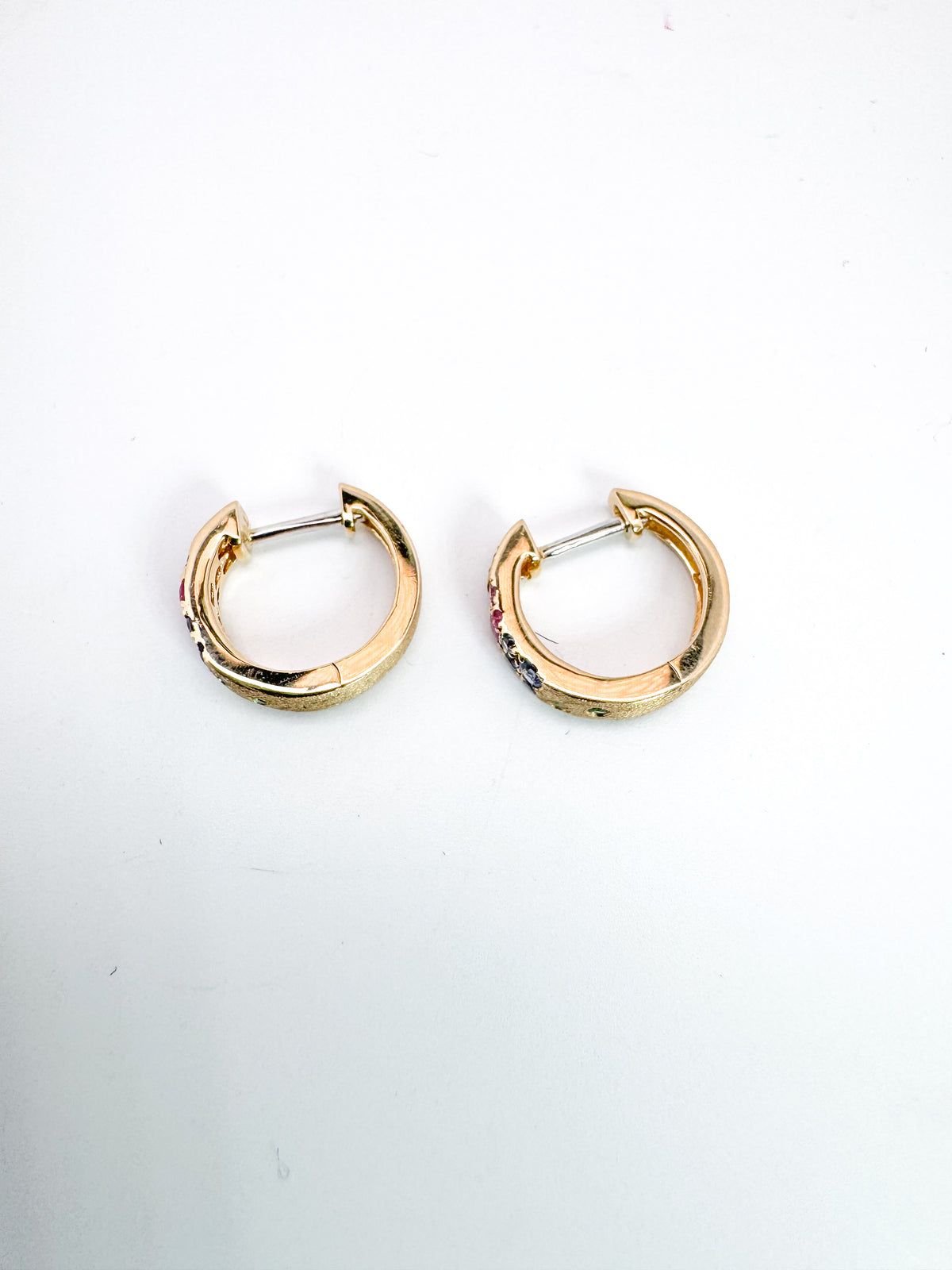 14K,Yellow gold, natural rainbow sapphire huggy earrings. .38 carat total weight.