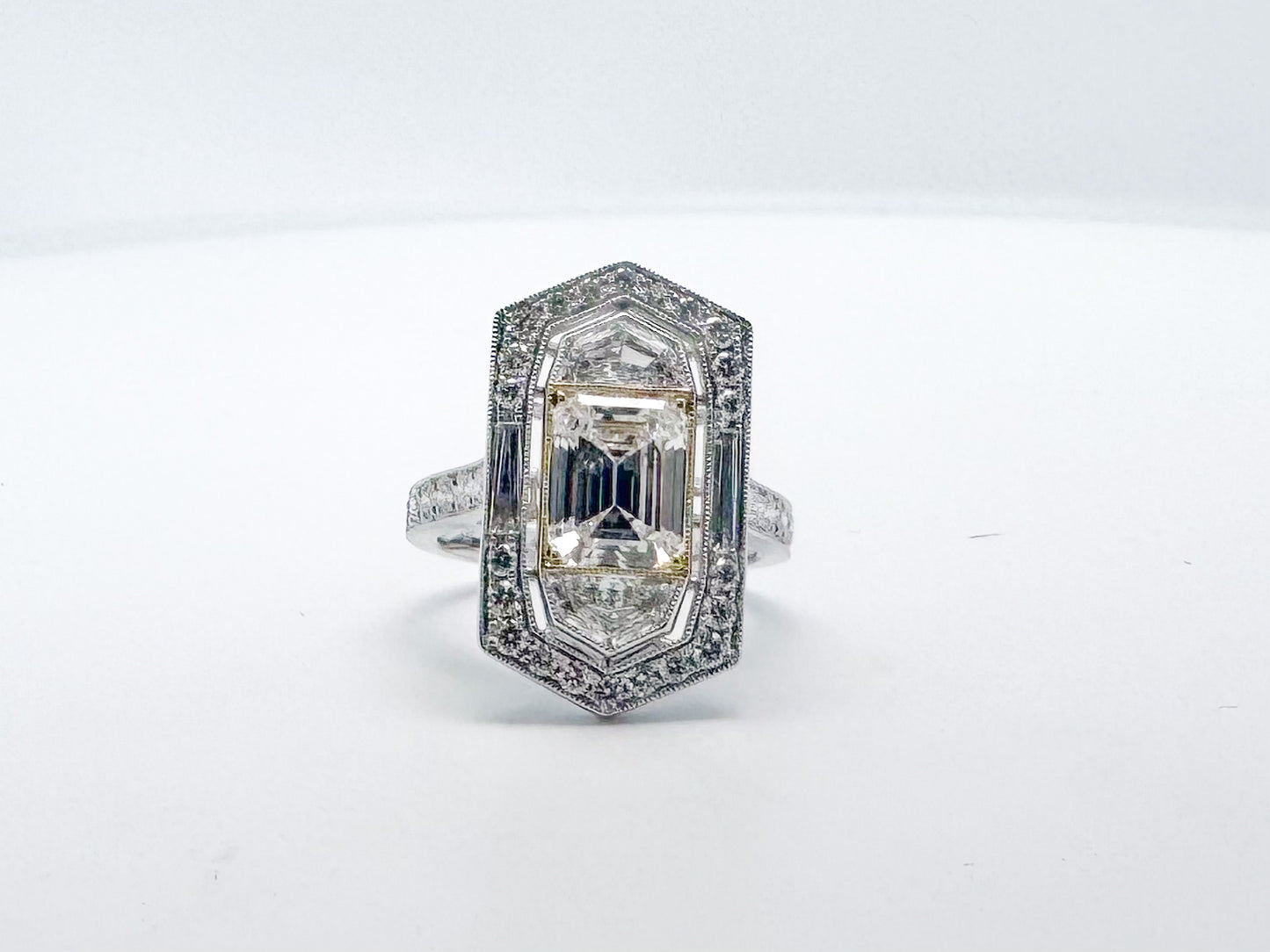 2.05 Natural VS1 E Emerald cut diamond set in classic diamond hidden halo engagemet ring. GIA certified