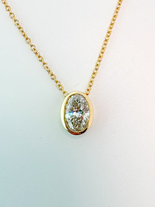 14K yellow gold ,  .71 Lab grown bezel set oval diamond pendant. G VS2