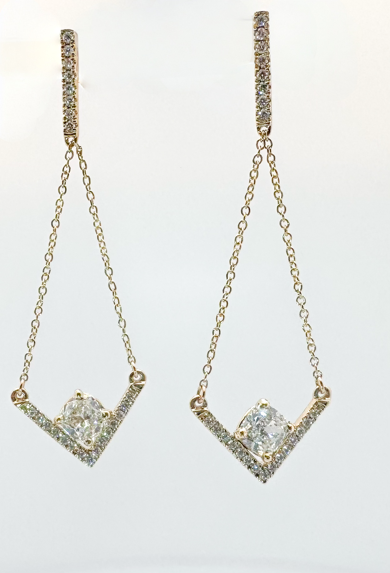 Custom chevron style dangle earrings with cushion cut diamond centers