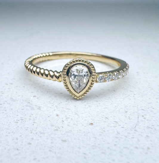 14k, yellow gold pear shaped diamond and round brilliant stacker band. .30 ctw side diamonds