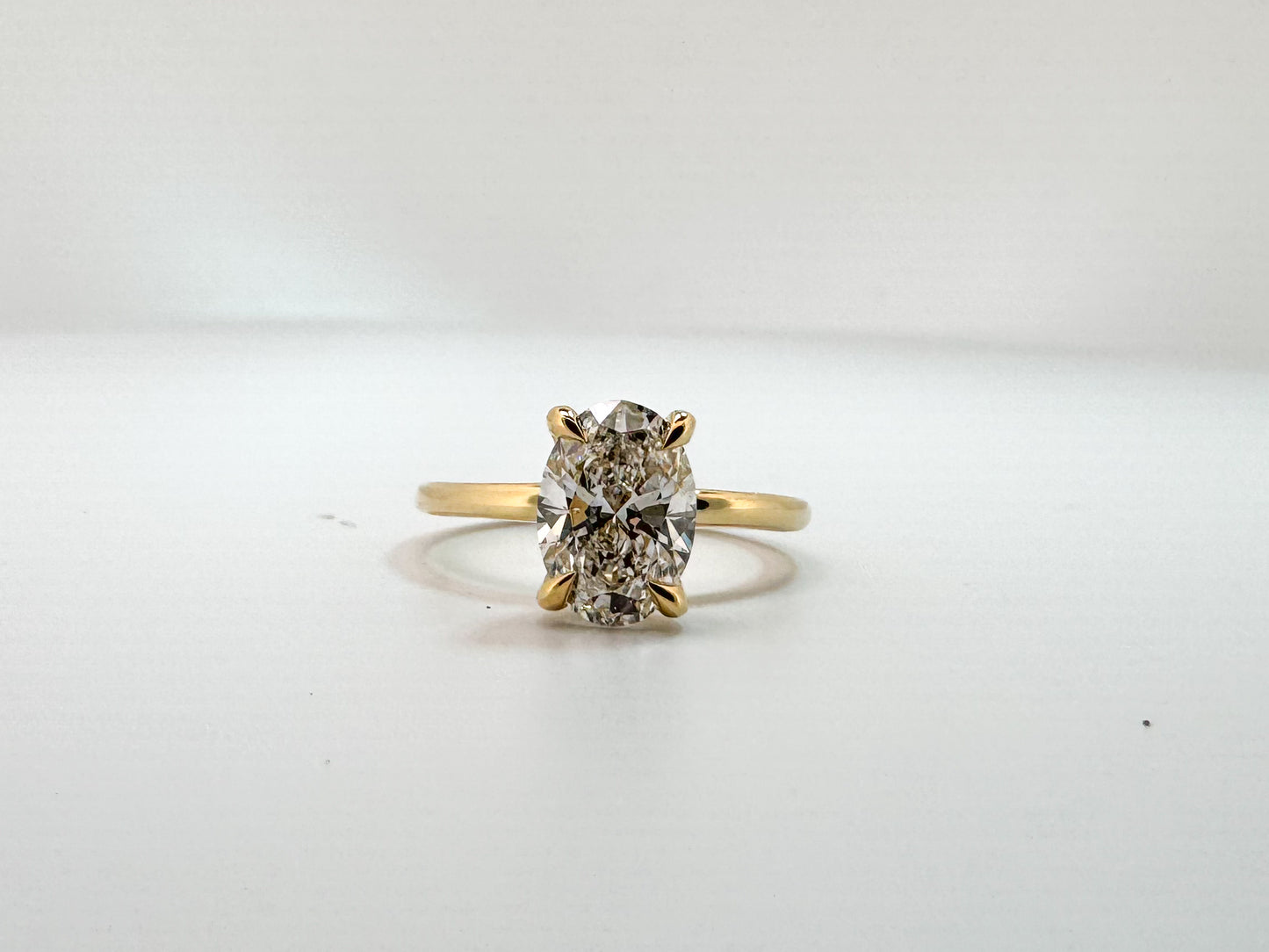 14k, Yellow gold 1.93 carat oval set with .07 dtw hidden halo.