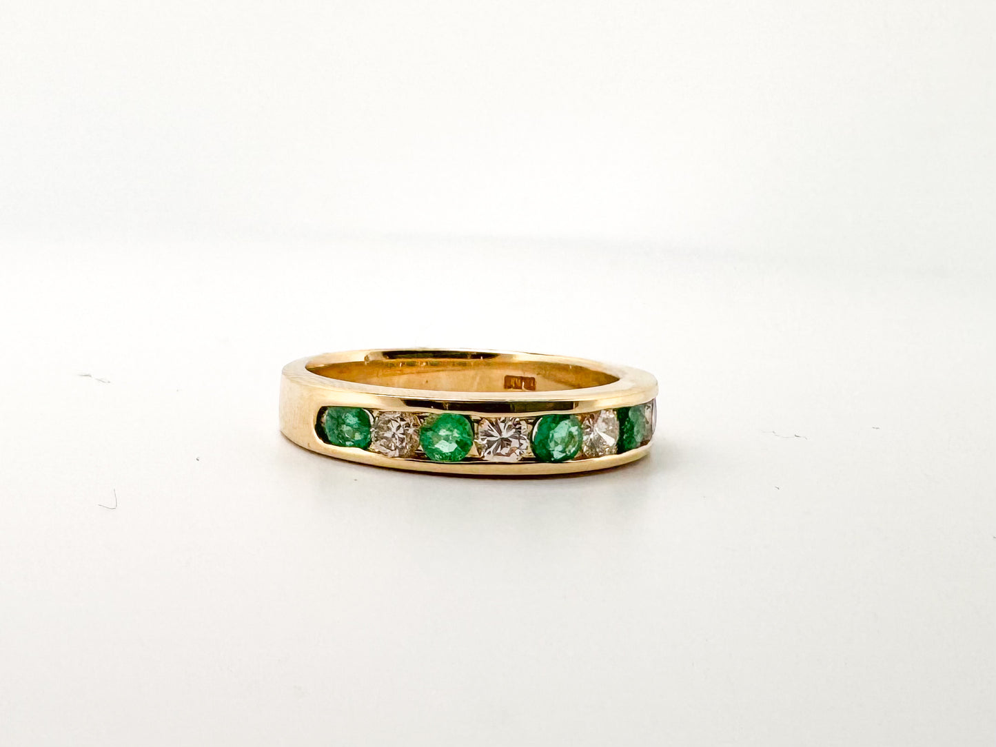 14k, Yellow gold, natural  emerald and diamond channel set band.