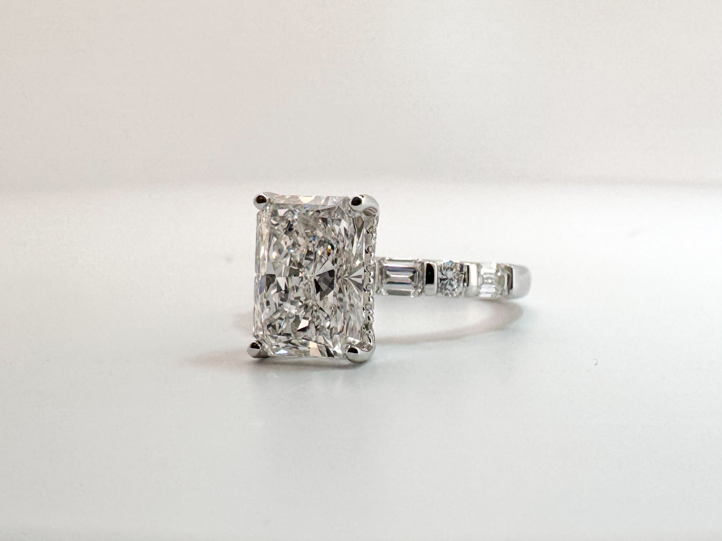 3.05 VS1 E, lab grown radiant cut diamond, set with .87 carats of side diamonds. IGI certified