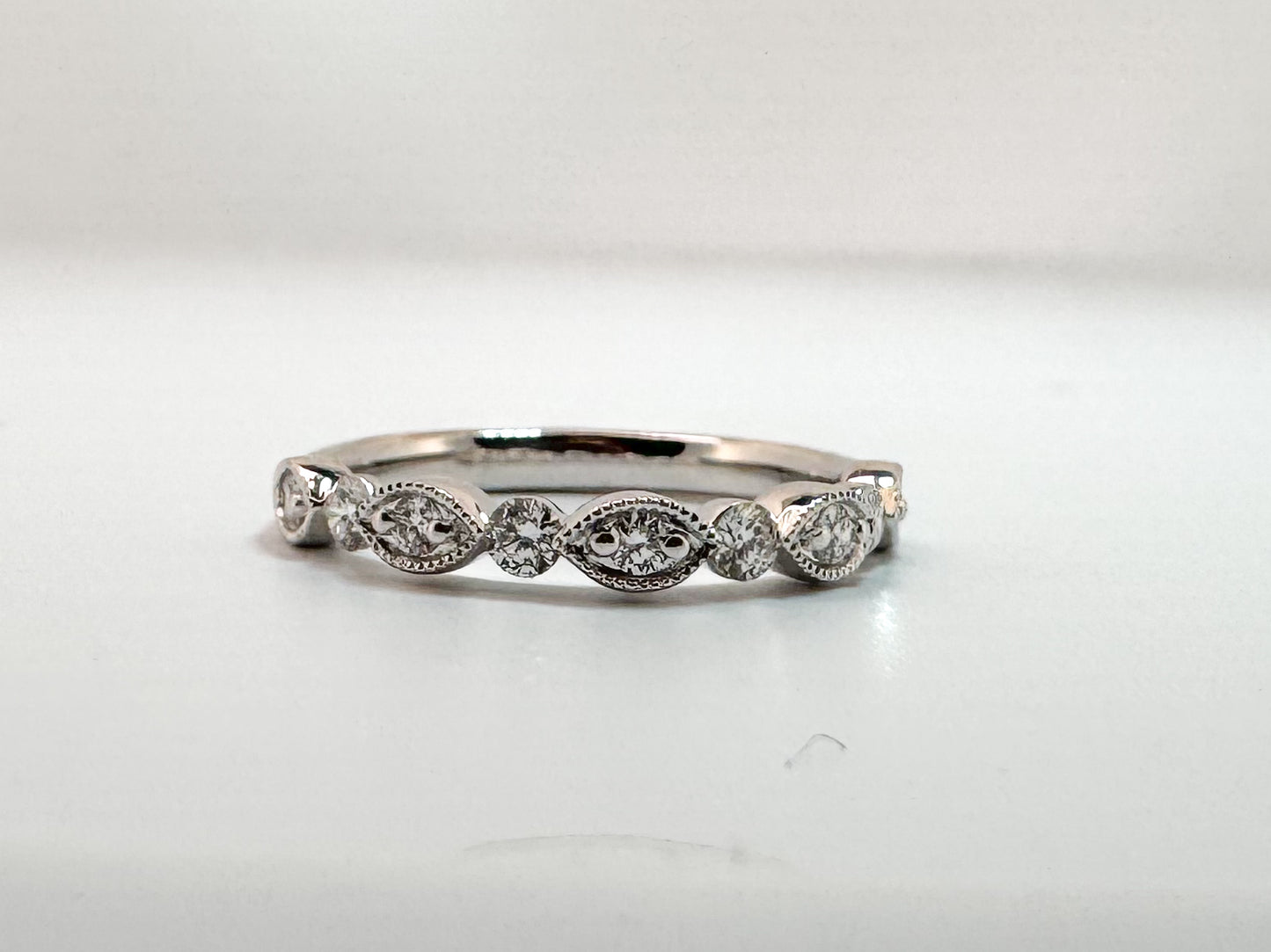 14K, White gold, .35 diamond total weight, scalloped band.