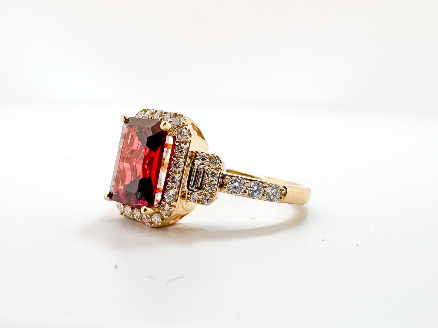 14K, Yellow gold, 2.50 carat garnet set with .50 side diamonds. Fashion ring