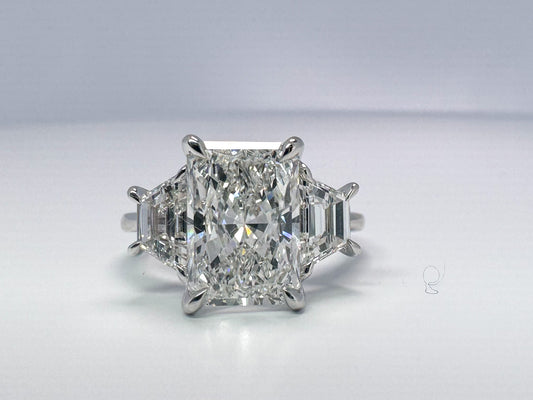 Lab grown radient cut diamond engagement ring with trapezoid sides.