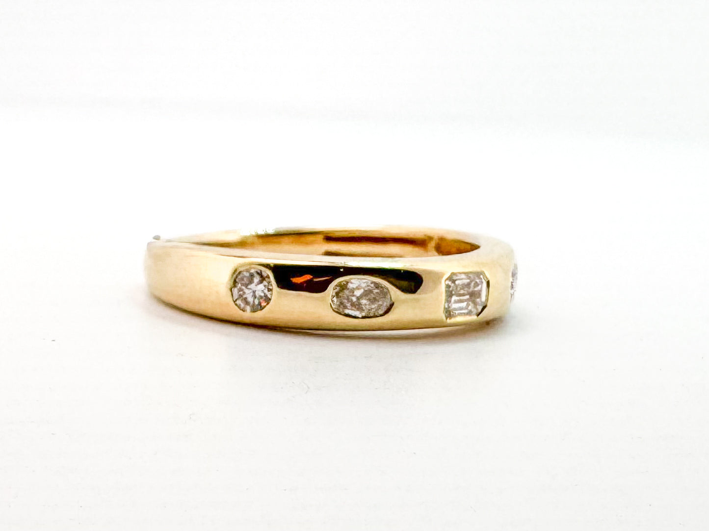 14k, Yellow gold, flush set, multi diamond shape band. .50 diamond total weight.
