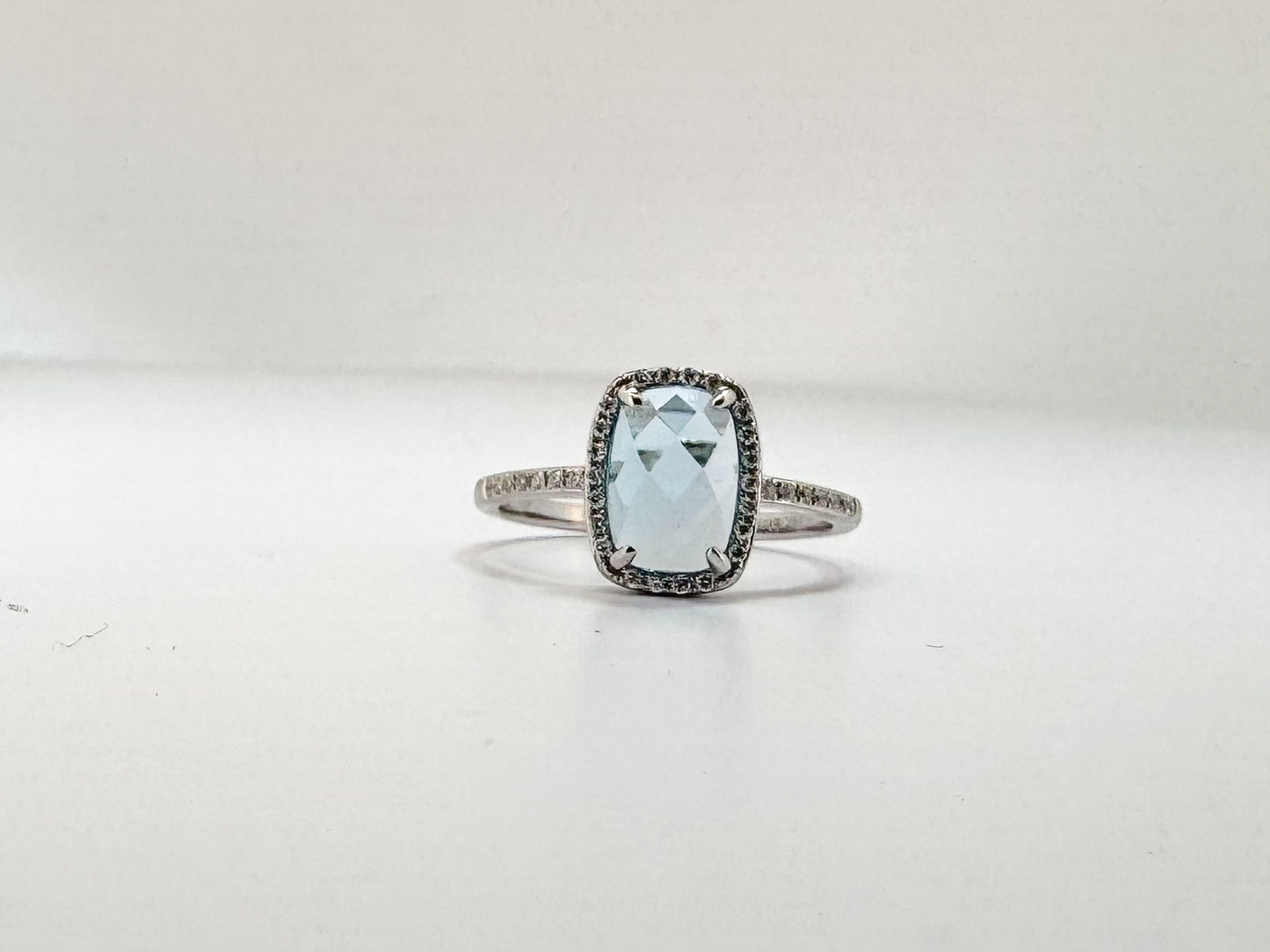 14K, White gold, 2.10 carat checker board cut, blue topaz, set with .14 carats of side diamonds.