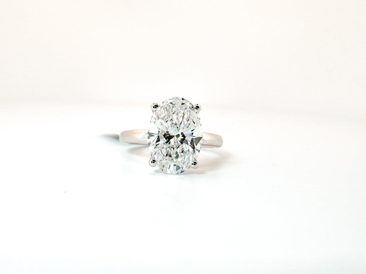 14k, White gold solitaire, set with 3.99 carat lab grown oval diamond. IGI Certified. VS 2 F