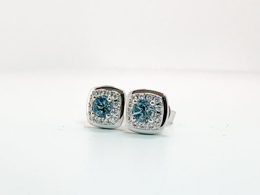 14k, white gold, .37 carats of Aquamarine surrounded by .13 carats of natural diamonds. Stud earring